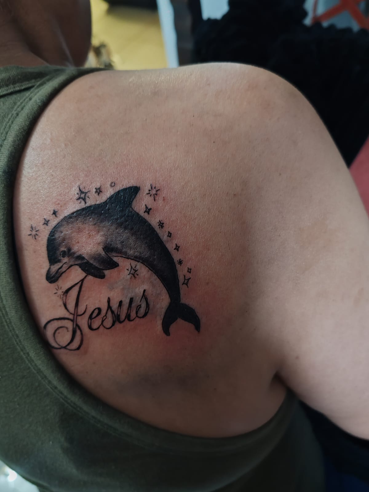 Black and grey animal tattoo on a hand